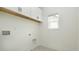 Well-lit laundry room featuring upper cabinets and a window for natural light at 1518 Gatekeeper Ter, Marietta, GA 30066