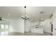 Open-concept living space with hardwood floors, modern light fixtures and access to the kitchen at 1518 Gatekeeper Ter, Marietta, GA 30066