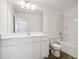 Bright bathroom featuring a white vanity with a large mirror and a tub-shower combination at 2109 Boxwood Se Cir, Conyers, GA 30094