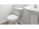 Small, bright half bath with a pedestal sink and white toilet at 2109 Boxwood Se Cir, Conyers, GA 30094