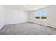 Bright bedroom featuring neutral carpet, white walls, and natural light from the double windows at 2109 Boxwood Se Cir, Conyers, GA 30094