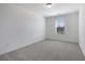 A well-lit bedroom with neutral carpet, one window with blinds and light-colored walls at 2109 Boxwood Se Cir, Conyers, GA 30094