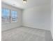 Bedroom with neutral carpet, and a view of the neighborhood through the window with blinds at 2109 Boxwood Se Cir, Conyers, GA 30094