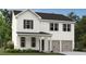 Charming two-story home with white siding, black roof, and a two-car garage at 2109 Boxwood Se Cir, Conyers, GA 30094