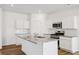 Modern kitchen featuring an island, white cabinetry, stainless steel appliances, and granite countertops at 2109 Boxwood Se Cir, Conyers, GA 30094
