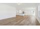 View of open-concept living room that goes into the kitchen with bright white walls and new floors at 2109 Boxwood Se Cir, Conyers, GA 30094