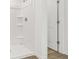 Clean shower with built-in shelving; the bathroom is conveniently located near a door at 2109 Boxwood Se Cir, Conyers, GA 30094