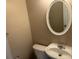 This powder room features a pedestal sink, toilet, and oval mirror at 3334 Rockmill Dr, Ellenwood, GA 30294