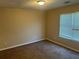Neutral bedroom features carpet, a window with blinds, and a ceiling light at 3334 Rockmill Dr, Ellenwood, GA 30294