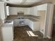 The kitchen features white cabinets, tile backsplash, and modern appliances at 3334 Rockmill Dr, Ellenwood, GA 30294