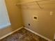 This laundry room features tile flooring, a utility sink, and a window for natural light at 3334 Rockmill Dr, Ellenwood, GA 30294