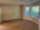 Inviting living room features neutral walls, plush carpeting, and an abundance of natural light at 3334 Rockmill Dr, Ellenwood, GA 30294