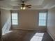 Spacious bedroom with carpet, natural light from two windows, and a ceiling fan at 3334 Rockmill Dr, Ellenwood, GA 30294