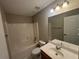 Standard bathroom with tub-shower combo and vanity with large mirror at 1365 Jubilee Ln, Mcdonough, GA 30253
