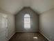 Carpeted bedroom with high angled ceiling and arched window at 1365 Jubilee Ln, Mcdonough, GA 30253