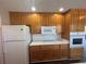 Kitchen with wood cabinets, white appliances, and a convenient layout at 1365 Jubilee Ln, Mcdonough, GA 30253