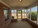 Enclosed brick patio with screening, windows and view of the backyard at 1365 Jubilee Ln, Mcdonough, GA 30253