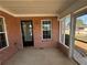 Screened patio with brick wall, white trim windows, and concrete flooring at 1365 Jubilee Ln, Mcdonough, GA 30253