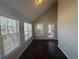 Sunroom featuring hardwood floor, three windows, high ceiling and back door at 1365 Jubilee Ln, Mcdonough, GA 30253