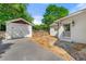 Home featuring detached garage, stone walkway, and inviting backyard at 218 Midvale Ne Dr, Atlanta, GA 30342