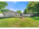 Expansive backyard showcasing a lush lawn, stone accents, and a detached garage, perfect for outdoor living at 218 Midvale Ne Dr, Atlanta, GA 30342
