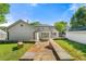 Picturesque backyard displaying a stone pathway, lush lawn, and a detached garage, creating a tranquil retreat at 218 Midvale Ne Dr, Atlanta, GA 30342