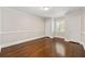 Bright bedroom featuring wood floors, neutral colors, and natural light at 218 Midvale Ne Dr, Atlanta, GA 30342
