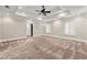 Large primary bedroom with a tray ceiling, plush carpet, and bright windows at 218 Midvale Ne Dr, Atlanta, GA 30342