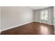 Bright bedroom with hardwood floors, shuttered windows, and neutral paint at 218 Midvale Ne Dr, Atlanta, GA 30342