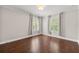 Large bedroom with plantation shutters, hardwood floors, and neutral paint at 218 Midvale Ne Dr, Atlanta, GA 30342