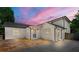 Beautiful white brick home exterior featuring a stone patio, updated windows and stylish outdoor lighting fixtures at 218 Midvale Ne Dr, Atlanta, GA 30342