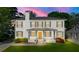 Inviting two-story home with painted brick, shutters, and landscaped front yard, offering great curb appeal at 218 Midvale Ne Dr, Atlanta, GA 30342