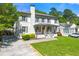 Charming two-story home featuring a well-manicured lawn, a covered front porch, and a driveway at 218 Midvale Ne Dr, Atlanta, GA 30342