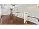 Hallway with hardwood floors, white railing, and neutral walls at 218 Midvale Ne Dr, Atlanta, GA 30342