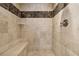 Elegant tiled shower with a built-in bench for added convenience at 218 Midvale Ne Dr, Atlanta, GA 30342
