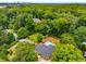 Aerial view of property showcasing its expansive lot, pool, and proximity to lush greenery and the city skyline at 3154 N Druid Hills Rd, Decatur, GA 30033