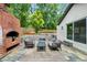 Backyard patio area with outdoor seating and a brick outdoor fireplace that enhances outdoor living at 3154 N Druid Hills Rd, Decatur, GA 30033