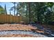 Scenic backyard featuring a wooden fence, gravel landscaping, and stone benches at 3154 N Druid Hills Rd, Decatur, GA 30033