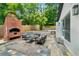 Backyard patio area with outdoor seating and a brick outdoor fireplace that enhances outdoor living at 3154 N Druid Hills Rd, Decatur, GA 30033