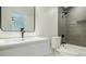 Modern bathroom featuring a sleek sink, gray herringbone tile in the shower, and minimalist design at 3154 N Druid Hills Rd, Decatur, GA 30033