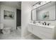 Chic bathroom with double sink vanity, marbled tile, and modern fixtures at 3154 N Druid Hills Rd, Decatur, GA 30033