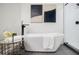 Modern bathroom with soaking tub, glass shower, and sleek black fixtures at 3154 N Druid Hills Rd, Decatur, GA 30033
