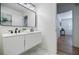 Bright bathroom featuring marble tile floor, floating vanity, double sinks, and modern lighting at 3154 N Druid Hills Rd, Decatur, GA 30033