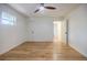 Bright bedroom featuring hardwood floors, ceiling fan, three windows, and neutral paint at 3154 N Druid Hills Rd, Decatur, GA 30033