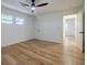 Bright bedroom featuring hardwood floors, ceiling fan, three windows, and neutral paint at 3154 N Druid Hills Rd, Decatur, GA 30033