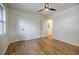 Bedroom features hardwood floors, a ceiling fan, one window, and two white doors at 3154 N Druid Hills Rd, Decatur, GA 30033