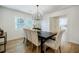 Dining room featuring a wooden table with six chairs and views of the outdoors at 3154 N Druid Hills Rd, Decatur, GA 30033