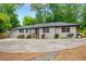 One-story painted brick home featuring a spacious front yard, modern windows, and convenient garage access at 3154 N Druid Hills Rd, Decatur, GA 30033