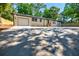 Single-story home with attached garage and large front parking pad at 3154 N Druid Hills Rd, Decatur, GA 30033