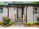Welcoming entryway with stone steps, wooden railings, fresh plants, and a bright white front door at 3154 N Druid Hills Rd, Decatur, GA 30033